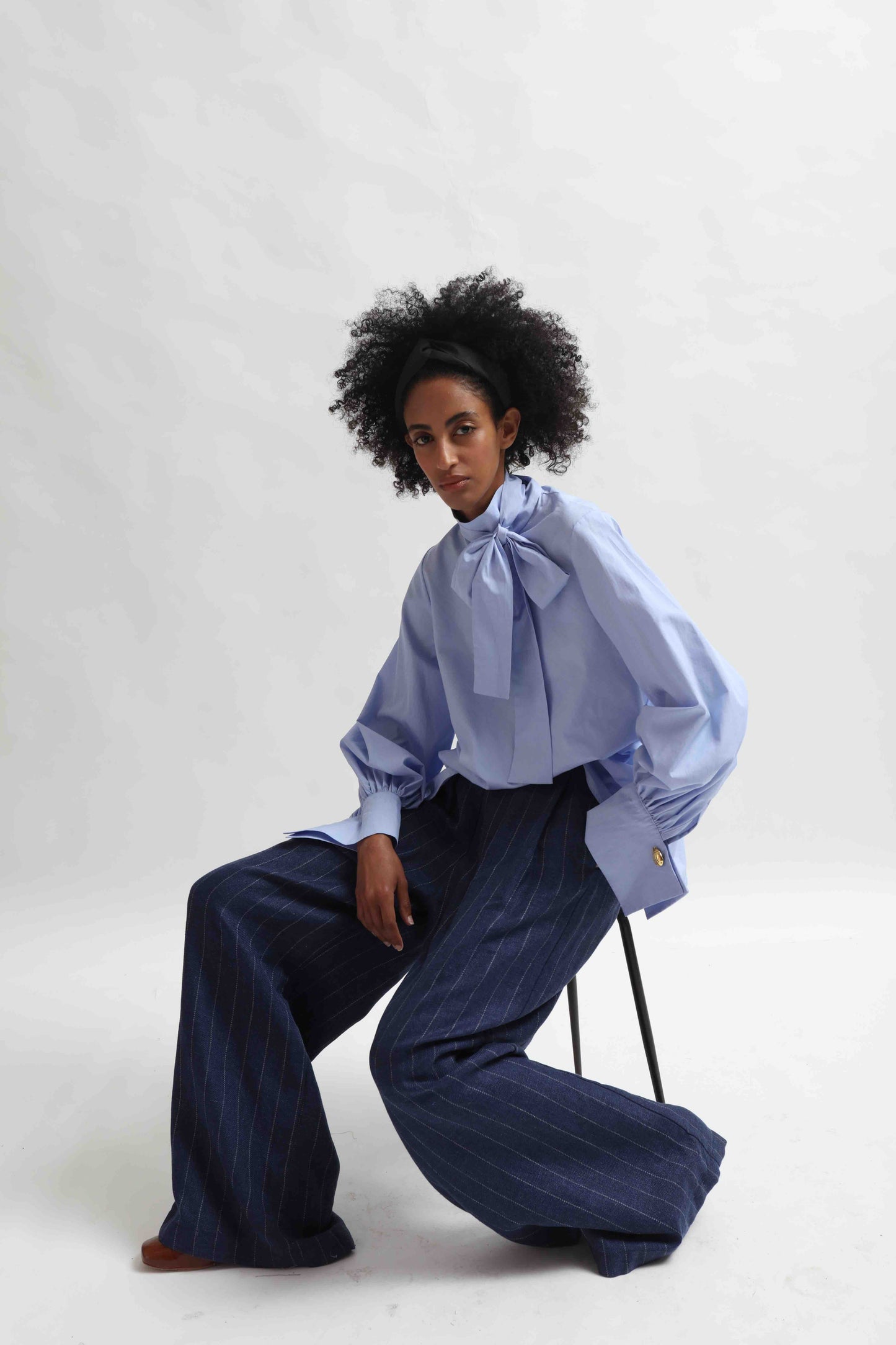 Sky Blue organic cotton blouse by House of Woven Stories, featuring a signature adjustable tie-neck detail. Ethically made in Italy in small batches from soft, premium poplin.