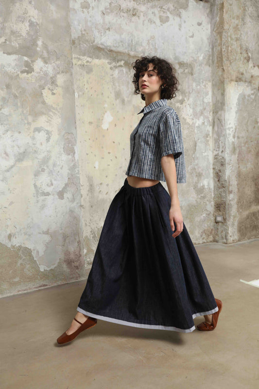 Seul Denim Skirt with striped cotton details and side pockets, handcrafted in Italy by House of Woven Stories. Sustainable, versatile midi skirt combining comfort and modern style.