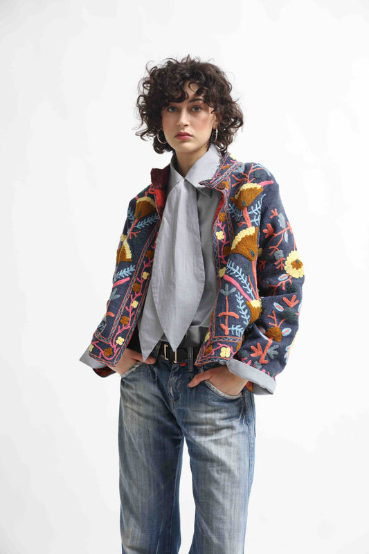 Suzani Short Jacket by House of Woven Stories. Hand-embroidered 100% cotton jacket with traditional Indian Suzani embroidery, lined with upcycled silk from antique saris, crafted sustainably in Italy.