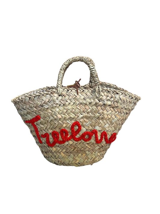 Handwoven bag from dried dwarf palm leaves with “Treelover” embroidery, leather drawstring closure, and lined interior by Micaela Spadoni.
