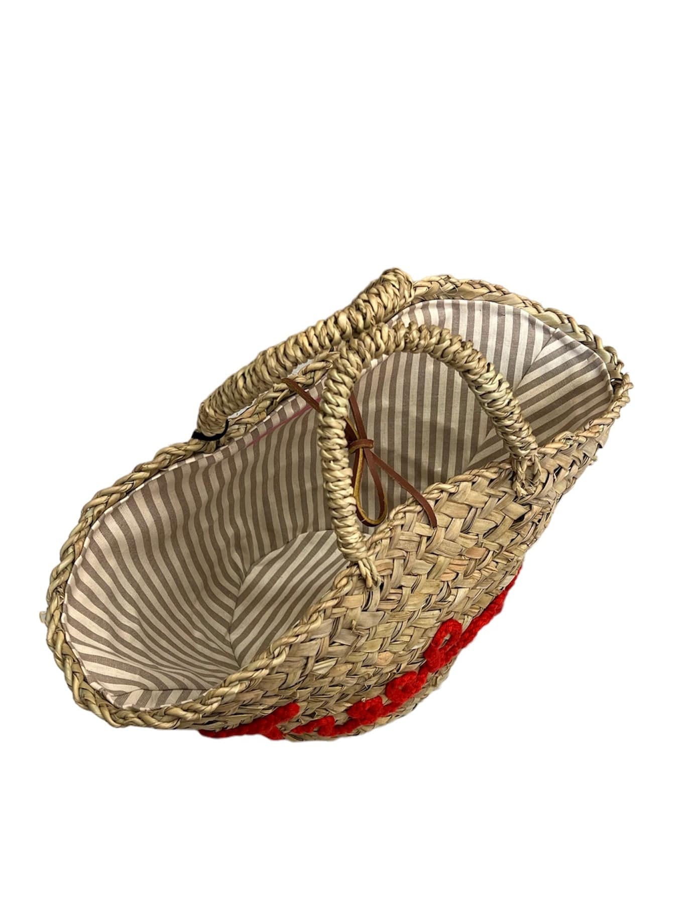 Handwoven bag from dried dwarf palm leaves with “Treelover” embroidery, leather drawstring closure, and lined interior by Micaela Spadoni.