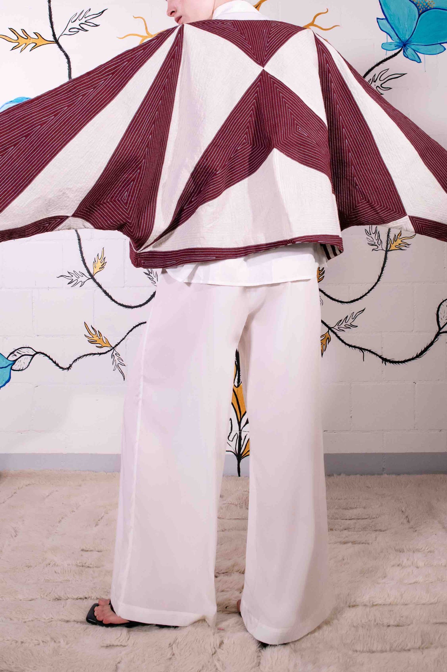 Cropped jacket in heavyweight organic cotton with hand-applied appliqué and embroidery by Ka-Sha. Features fabric button closure and easy-fit silhouette. Ethically handcrafted in India.