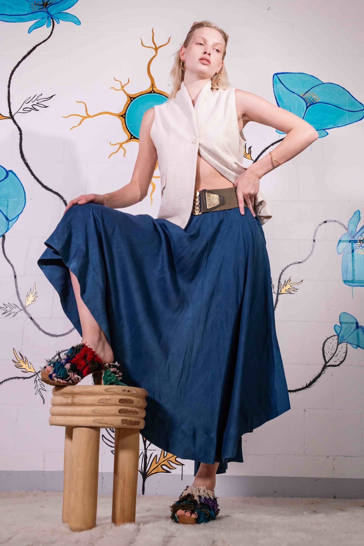 Model is wearing a natural Kala cotton waistcoat by IOWEYOU with a single-button closure and clean, minimalist design. Part of House of Woven Stories selection.