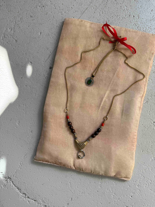 Bold Urban Tribe Ring Pendant by Ilaria Fiorentini Jewellery, blending ethnic and modern design. Handcrafted in Italy with red bamboo coral, turquoise paste, amber resin, brass, wood, leather, and a brass medallion. Part of House of Woven Stories selection.