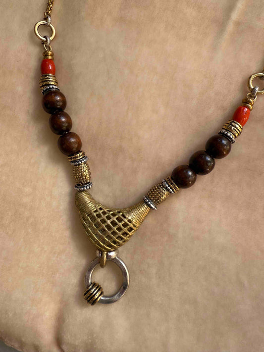 Bold Urban Tribe Ring Pendant by Ilaria Fiorentini Jewellery, blending ethnic and modern design. Handcrafted in Italy with red bamboo coral, turquoise paste, amber resin, brass, wood, leather, and a brass medallion. Part of House of Woven Stories selection.