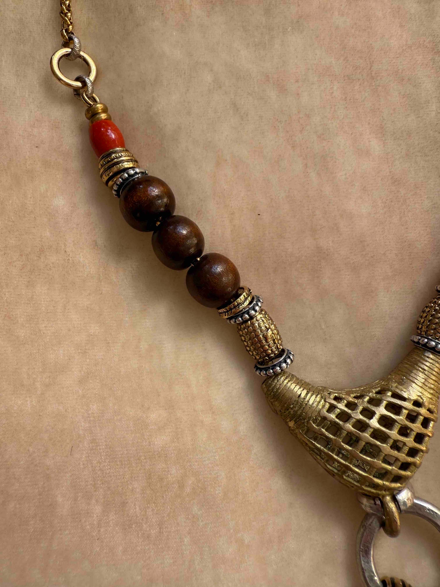 Bold Urban Tribe Ring Pendant by Ilaria Fiorentini Jewellery, blending ethnic and modern design. Handcrafted in Italy with red bamboo coral, turquoise paste, amber resin, brass, wood, leather, and a brass medallion. Part of House of Woven Stories selection.