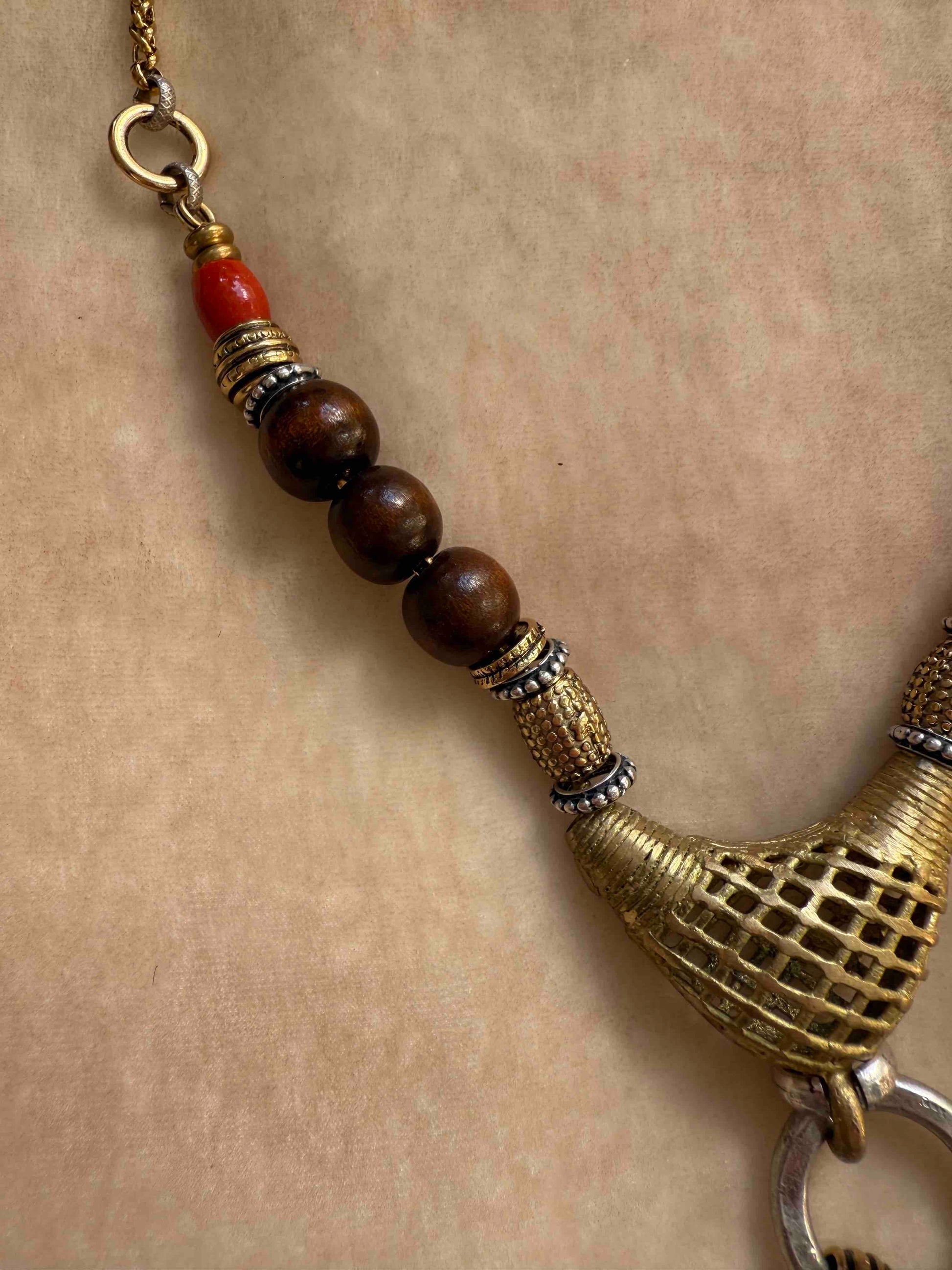 Bold Urban Tribe Ring Pendant by Ilaria Fiorentini Jewellery, blending ethnic and modern design. Handcrafted in Italy with red bamboo coral, turquoise paste, amber resin, brass, wood, leather, and a brass medallion. Part of House of Woven Stories selection.