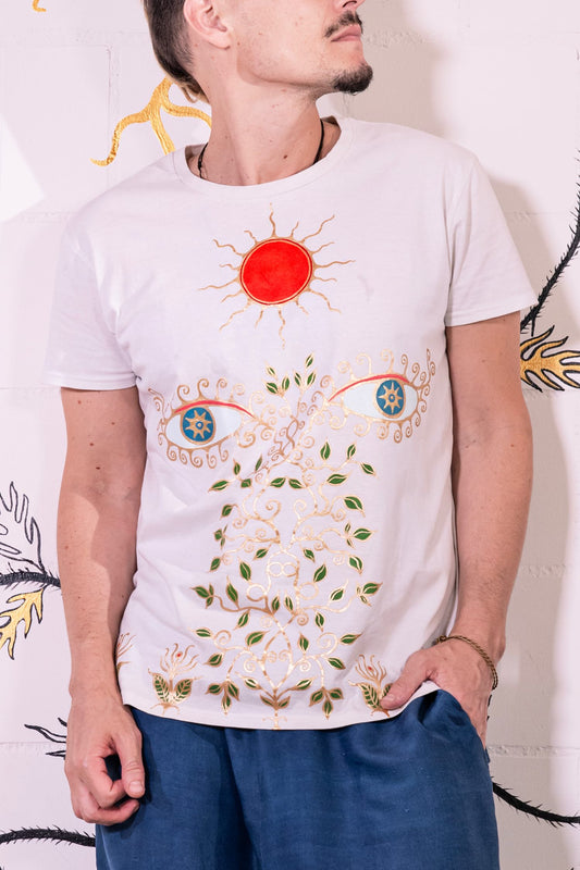 Artist Didè Comte wearing the Aria white hand-painted organic cotton T-shirt by House of Woven Stories, featuring her original artwork.