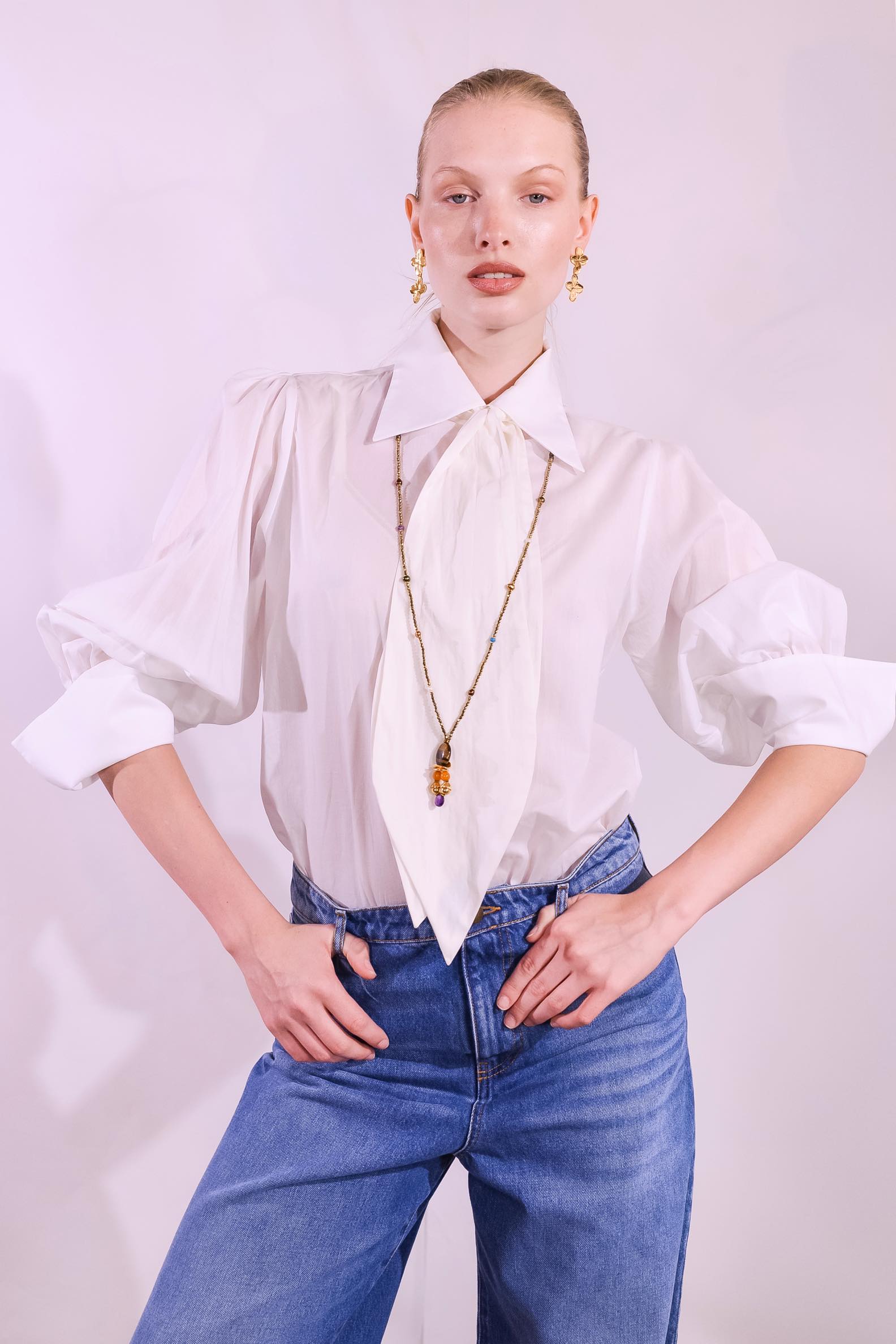 Model wearing the Karin 2 white cotton blouse handmade in Italy with removable tie by House of Woven Stories
