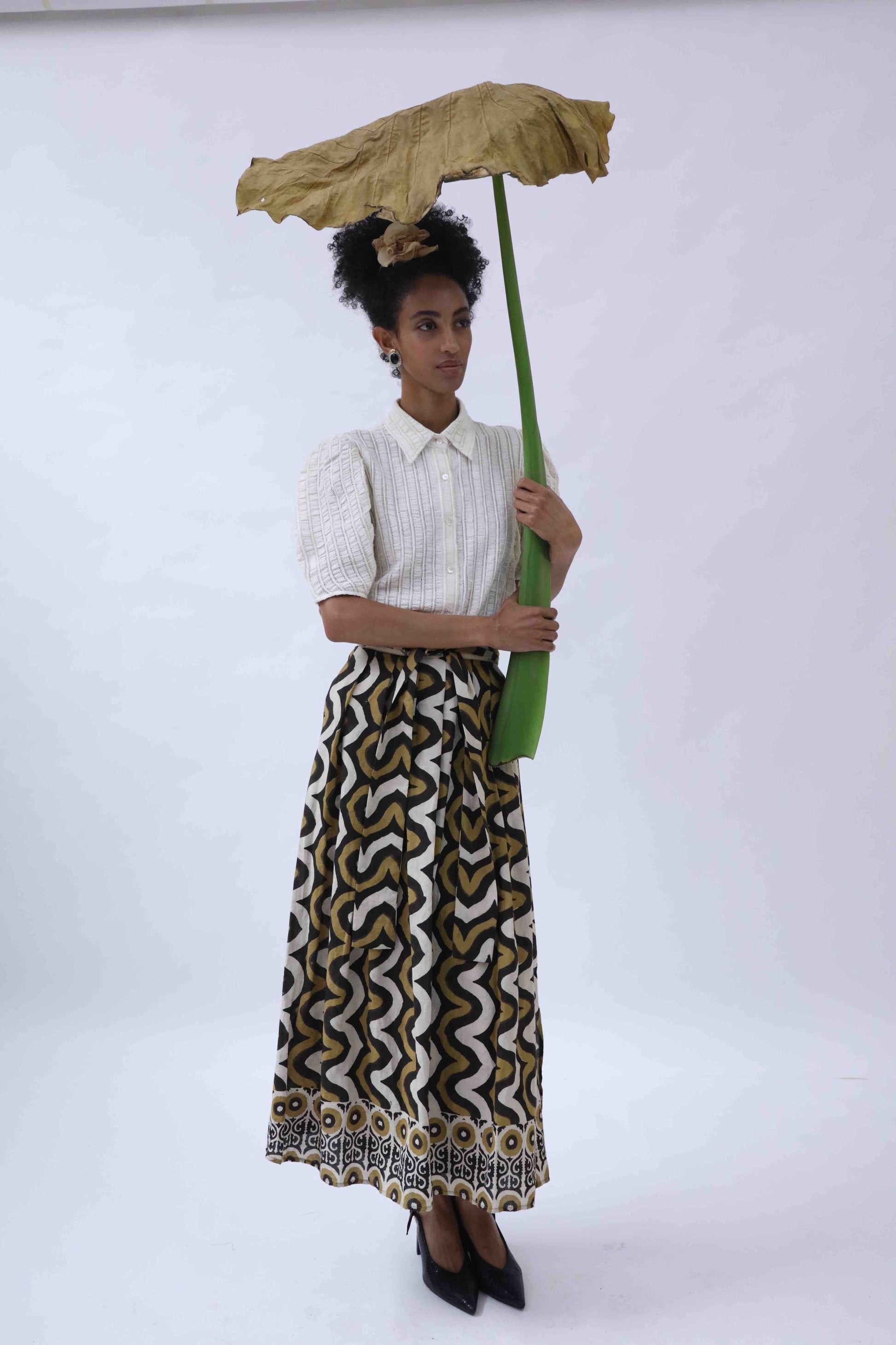 Structured puff-sleeve blouse crafted from upcycled cotton waste and T-shirt scraps, featuring a breathable leno weave. Handmade by Paiwand, combining traditional techniques with sustainable materials for a unique, eco-friendly garment.