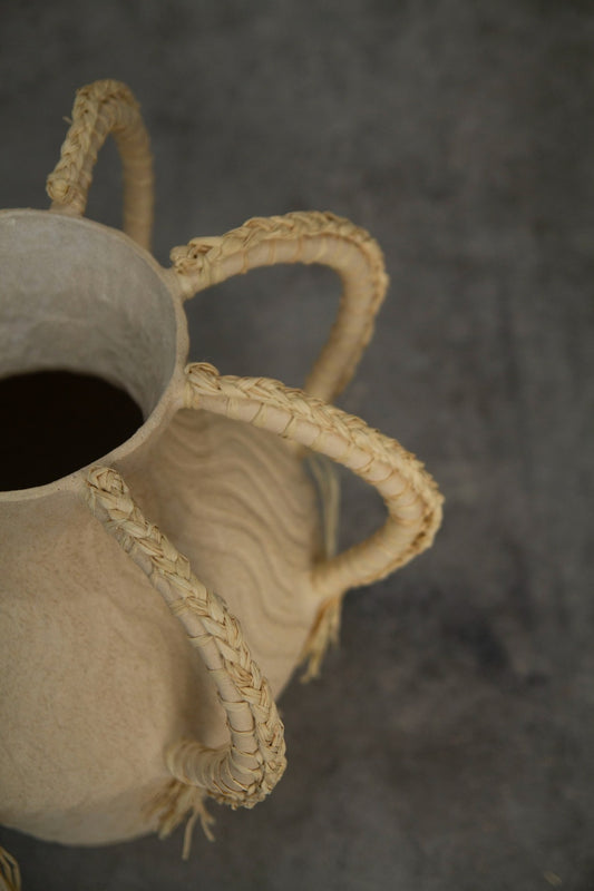 Amphora Ondas by Clandestine Céramique, handbuilt in sandy clay with engraved wave patterns and eight braided raphia handles, part of the House of Woven Stories selection.