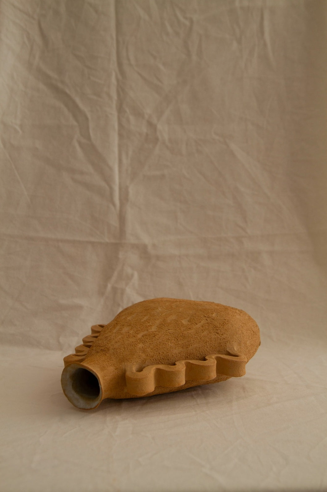 Handbuilt Amphora Soleil in sun-toned chamotte clay by Clandestine Céramique, featuring sculptural handles and a textured surface, available at House of Woven Stories.