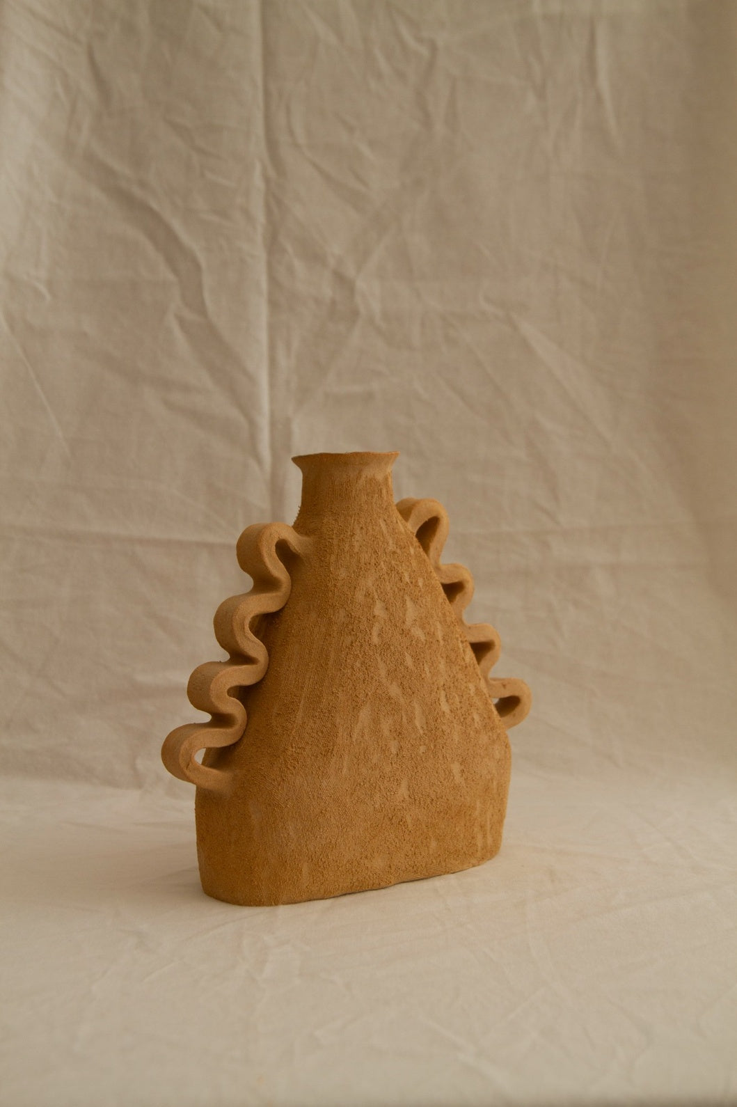 Handbuilt Amphora Soleil in sun-toned chamotte clay by Clandestine Céramique, featuring sculptural handles and a textured surface, available at House of Woven Stories.