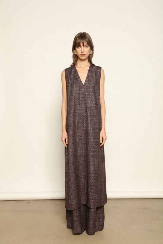 Model is wearing the Athen Burgundy Tunic Dress by House of Woven Stories, made from a wool, silk, and cashmere blend with longline silhouette and deep V-neck.