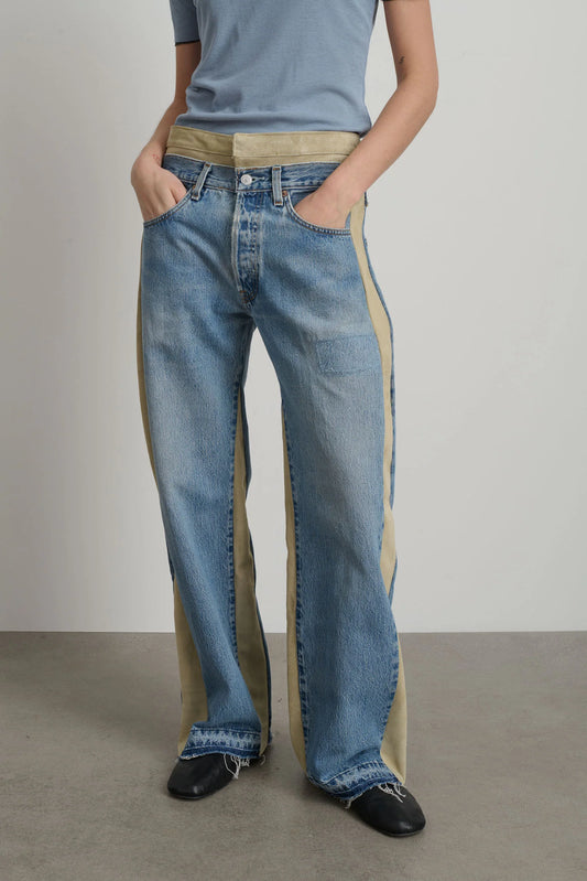 Model is wearing B Sides Double Waistband Rework Jeans in vintage indigo denim with Italian calf suede waistband, mid-rise relaxed fit, 30-inch inseam, unique fade and details, from the curated selection of House of Woven Stories