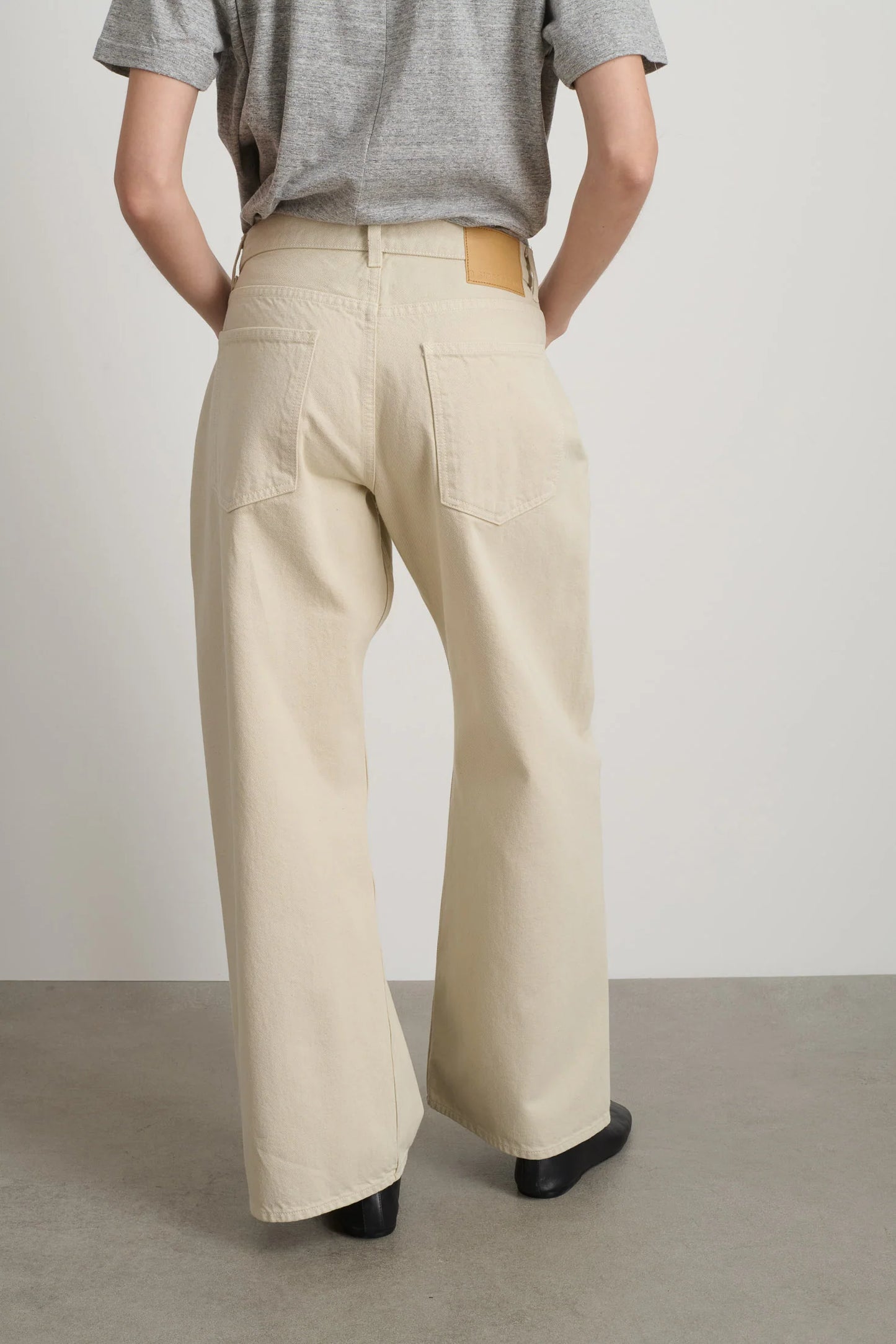 Model is wearing B Sides Floppy Jean Chalk Overdye in wide-leg cotton denim, mid-rise relaxed fit, 28-inch inseam, stonewashed chalk finish, from the curated selection of House of Woven Stories