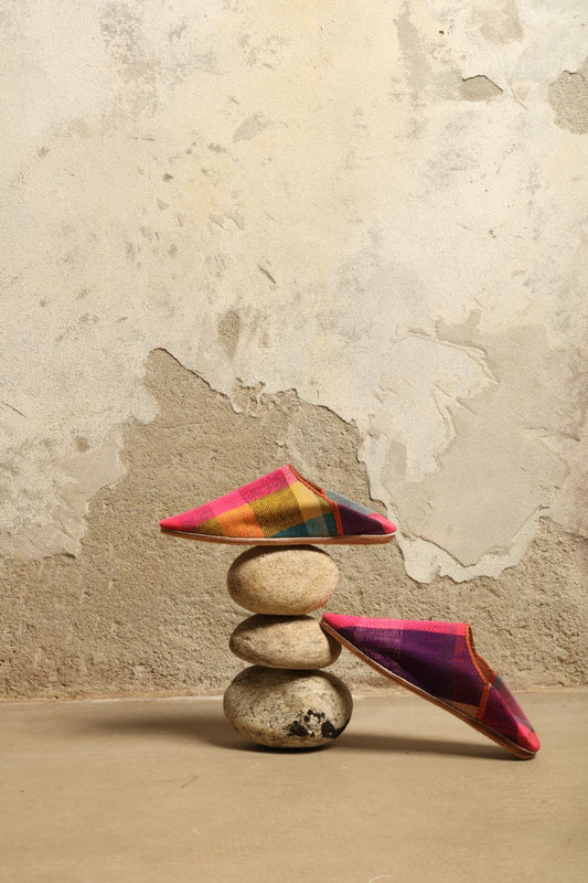 Model is wearing the Baboush in Kelim Fabric by House of Woven Stories, handmade in Marrakesh with colorful handwoven kilim textile and ethically sourced leather sole, showcasing authentic Moroccan craftsmanship.