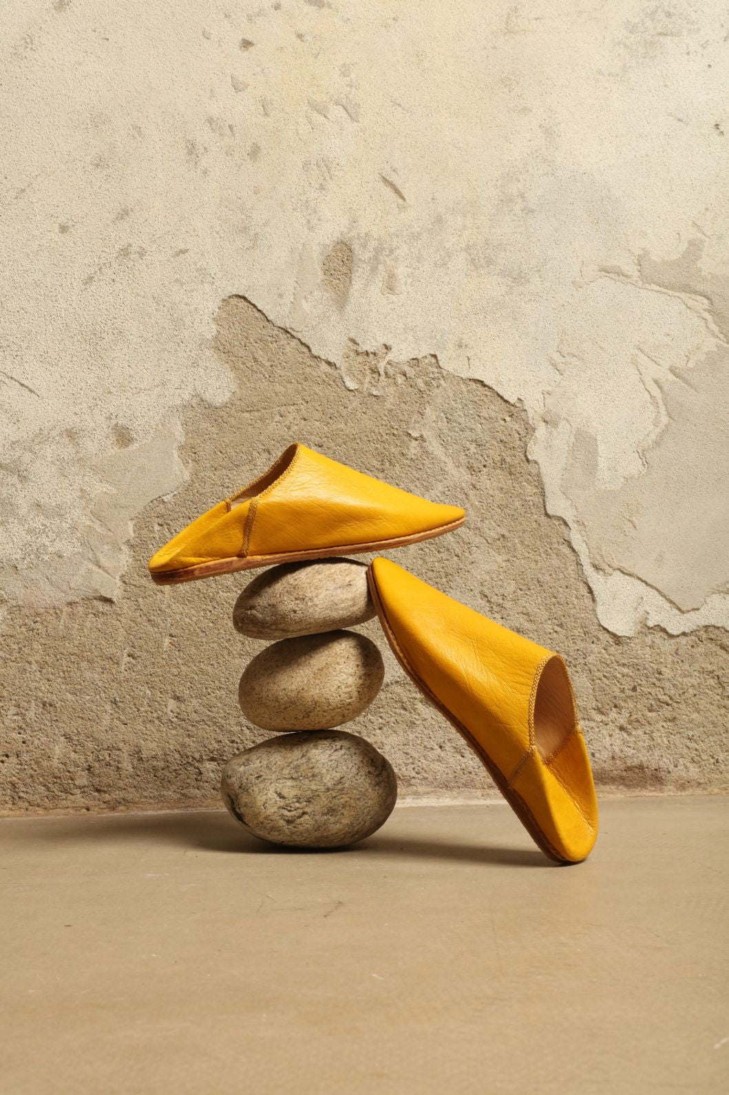 Model is wearing the Baboush in Yellow Leather by House of Woven Stories, handcrafted in Marrakesh from ethically sourced leather with a warm yellow hue, cushioned sole, and timeless Moroccan design.