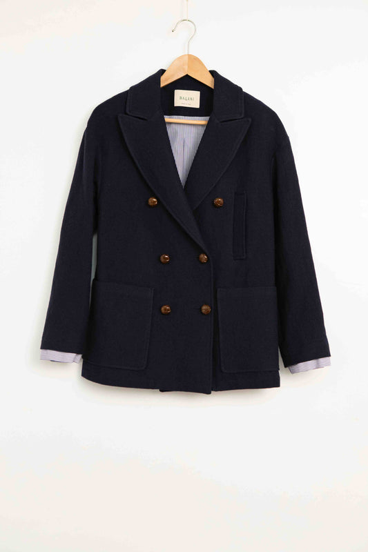 Model is wearing the Marine Blue Caban Jacket by Balia 8.22, crafted in Italy from virgin wool, cotton, and merino, part of the House of Woven Stories curated selection.