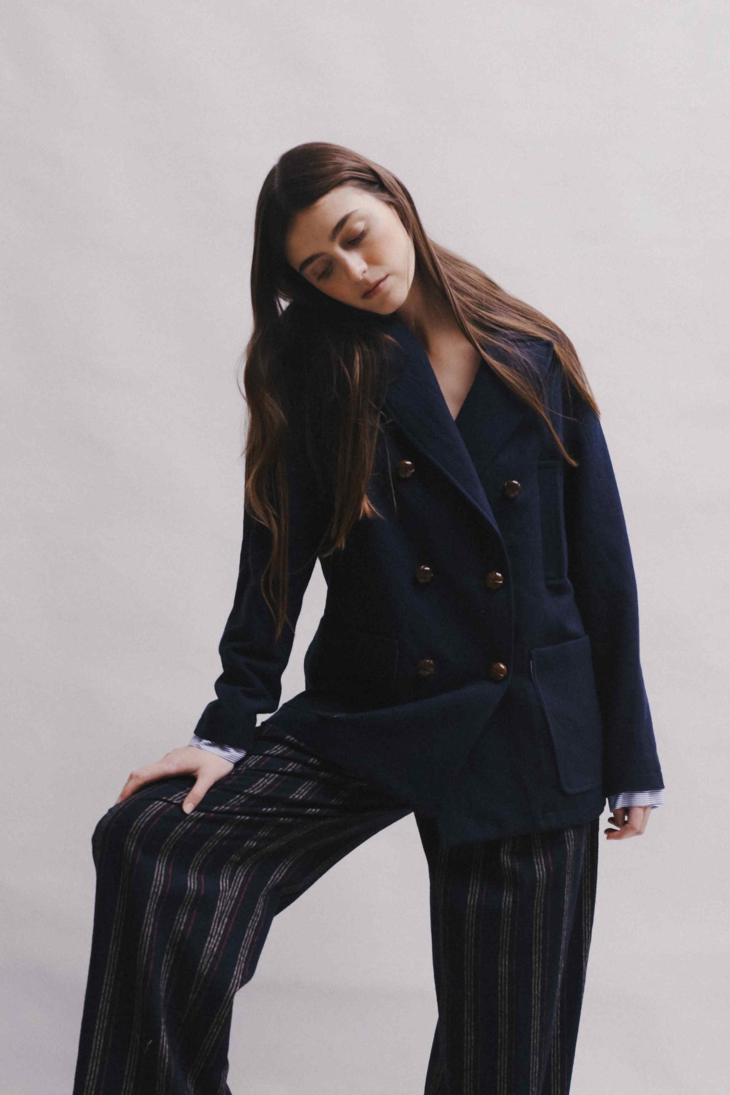 Model is wearing the Marine Blue Caban Jacket by Balia 8.22, crafted in Italy from virgin wool, cotton, and merino, part of the House of Woven Stories curated selection.