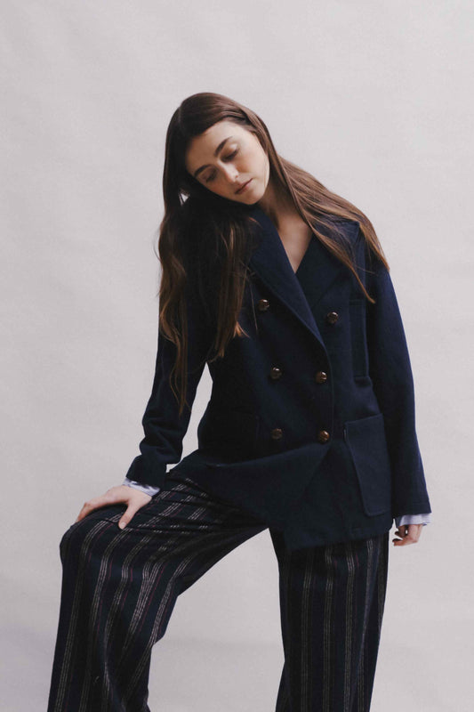 Model is wearing the Marine Blue Caban Jacket by Balia 8.22, crafted in Italy from virgin wool, cotton, and merino, part of the House of Woven Stories curated selection.