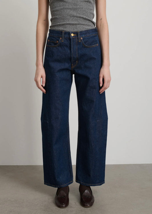 Model is wearing B Sides Lasso Jeans in double-faced Japanese denim, natural waist, kinked leg, cropped length, roped hem, with signature outseam detailing, part of House of Woven Stories curated collection.