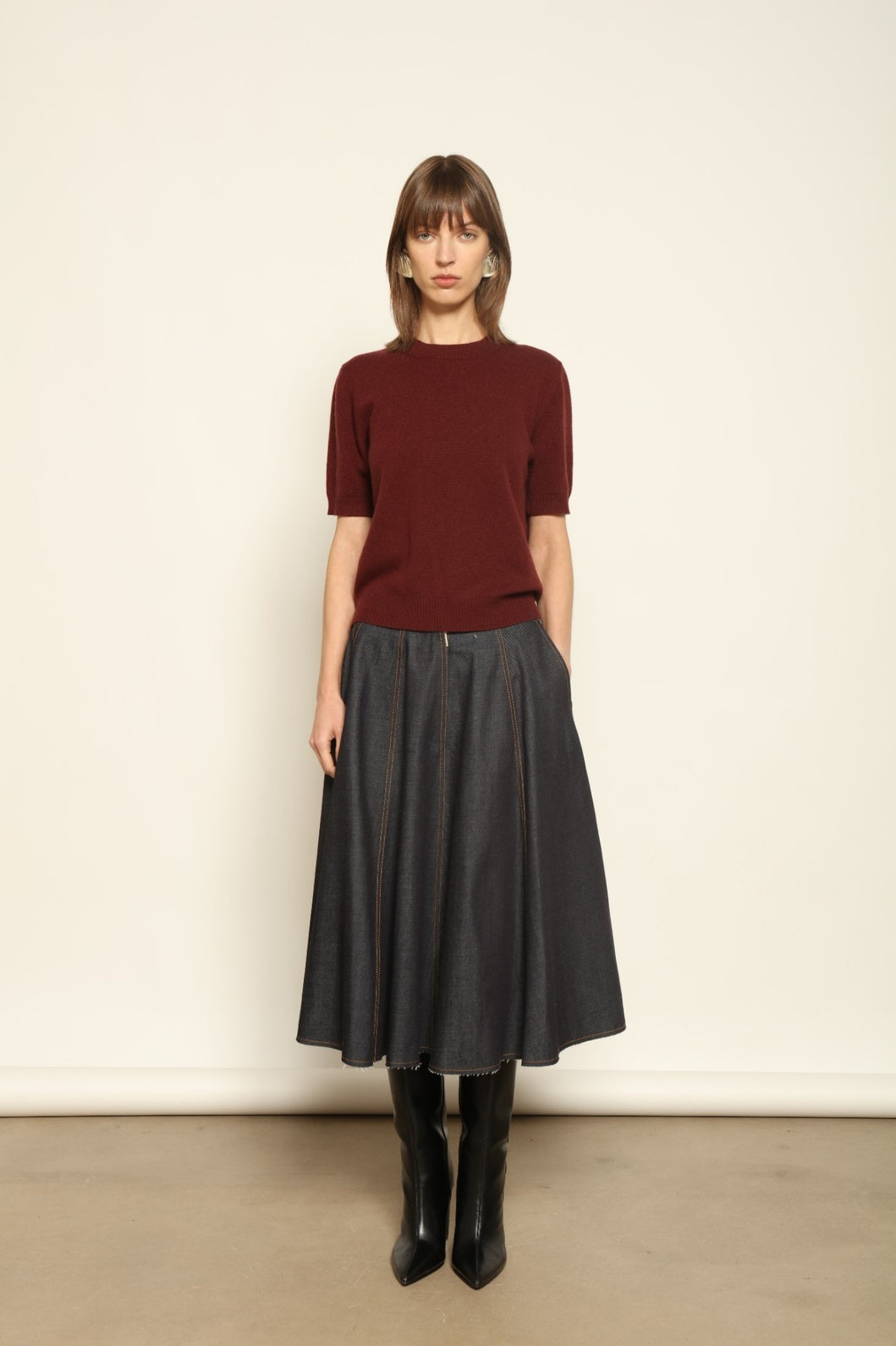 Model wearing the Burgundy Natascha Cashmere Pullover by House of Woven Stories, crafted from 100% pure Inner Mongolia cashmere, featuring a deep burgundy tone, soft breathable texture, round neckline, relaxed fit, and sustainable luxury craftsmanship