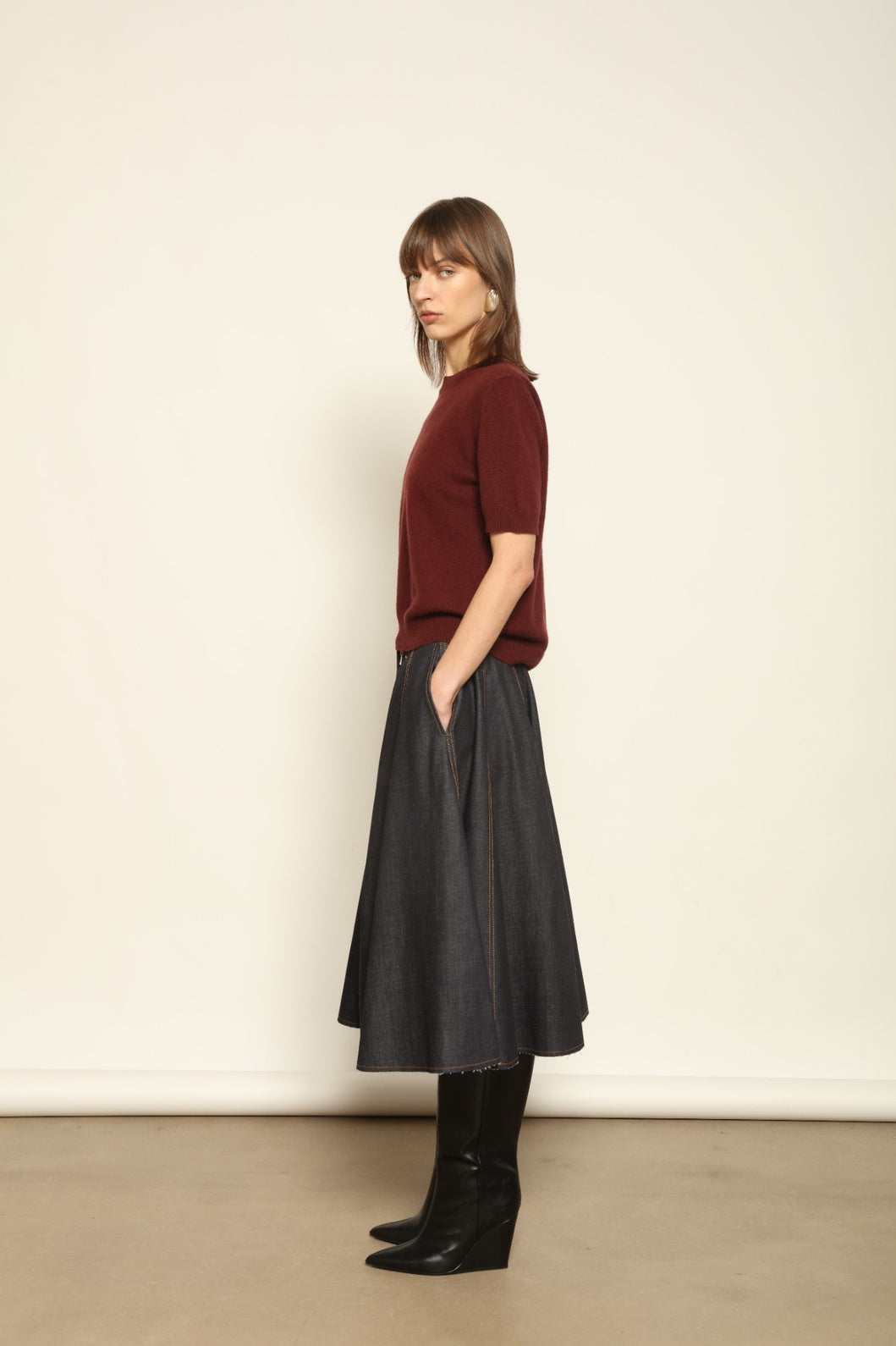 Model wearing the Burgundy Natascha Cashmere Pullover by House of Woven Stories, crafted from 100% pure Inner Mongolia cashmere, featuring a deep burgundy tone, soft breathable texture, round neckline, relaxed fit, and sustainable luxury craftsmanship