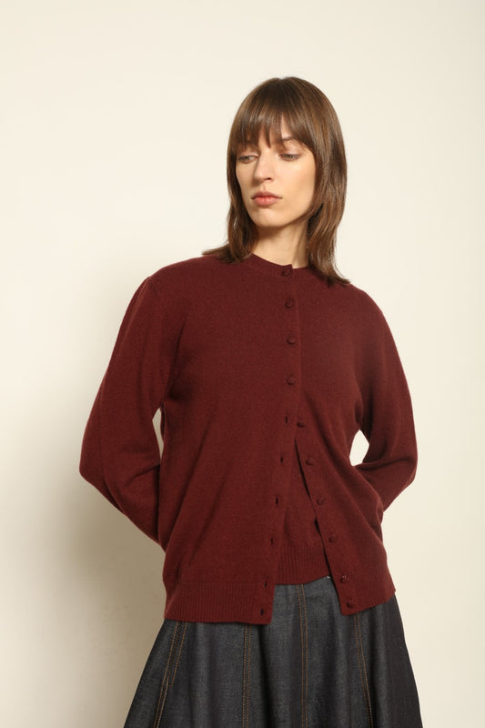 Model wearing the Burgundy Nathalie Cashmere Cardigan by House of Woven Stories, made from 100% pure Inner Mongolia cashmere, featuring a deep burgundy shade, open-front design, relaxed silhouette, flowing drape, and sustainable luxury craftsmanship