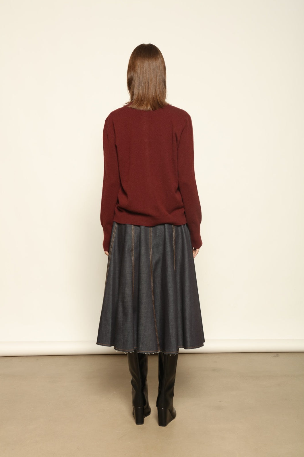 Model wearing the Burgundy Nathalie Cashmere Cardigan by House of Woven Stories, made from 100% pure Inner Mongolia cashmere, featuring a deep burgundy shade, open-front design, relaxed silhouette, flowing drape, and sustainable luxury craftsmanship