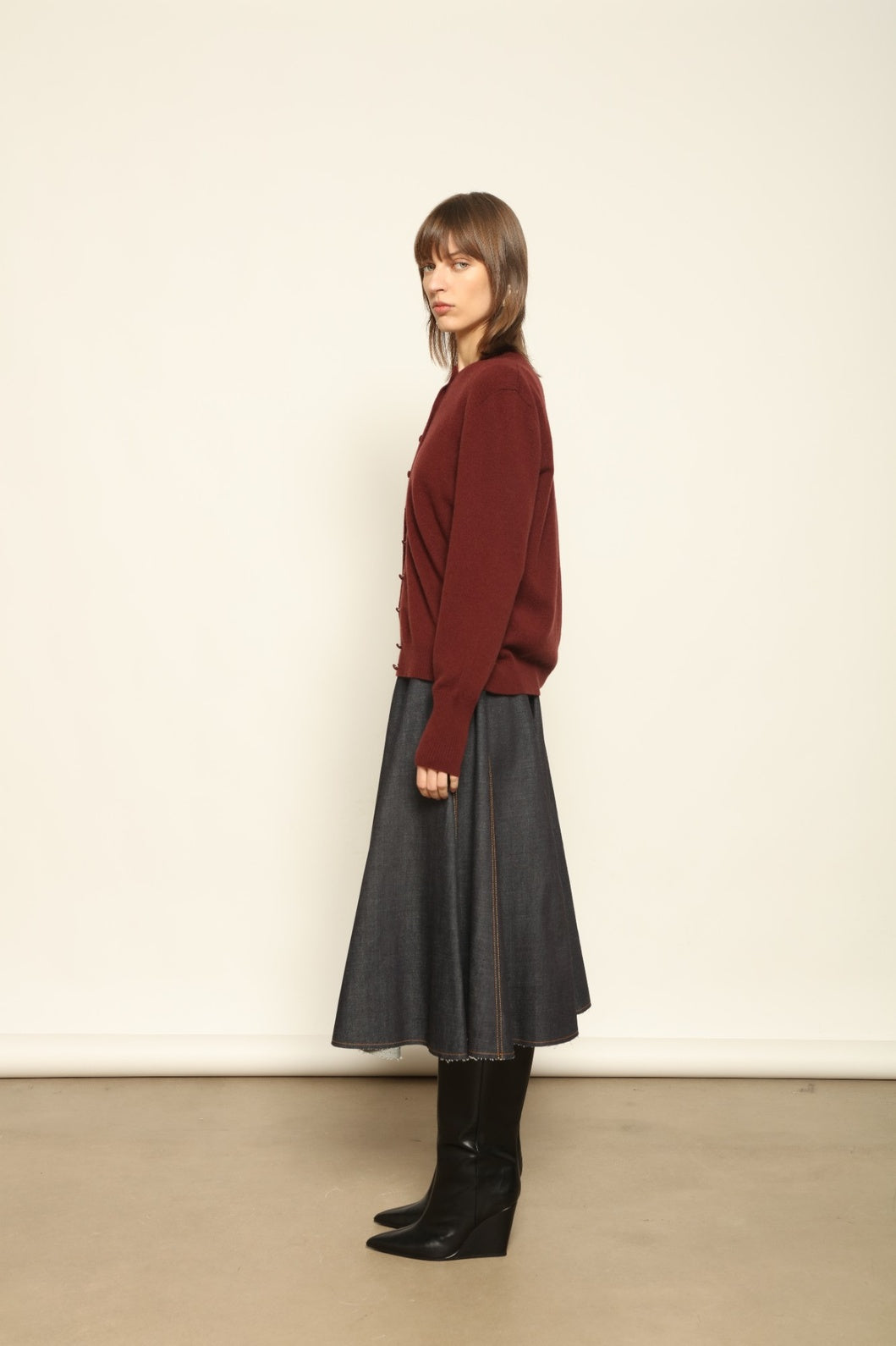 Model wearing the Burgundy Nathalie Cashmere Cardigan by House of Woven Stories, made from 100% pure Inner Mongolia cashmere, featuring a deep burgundy shade, open-front design, relaxed silhouette, flowing drape, and sustainable luxury craftsmanship