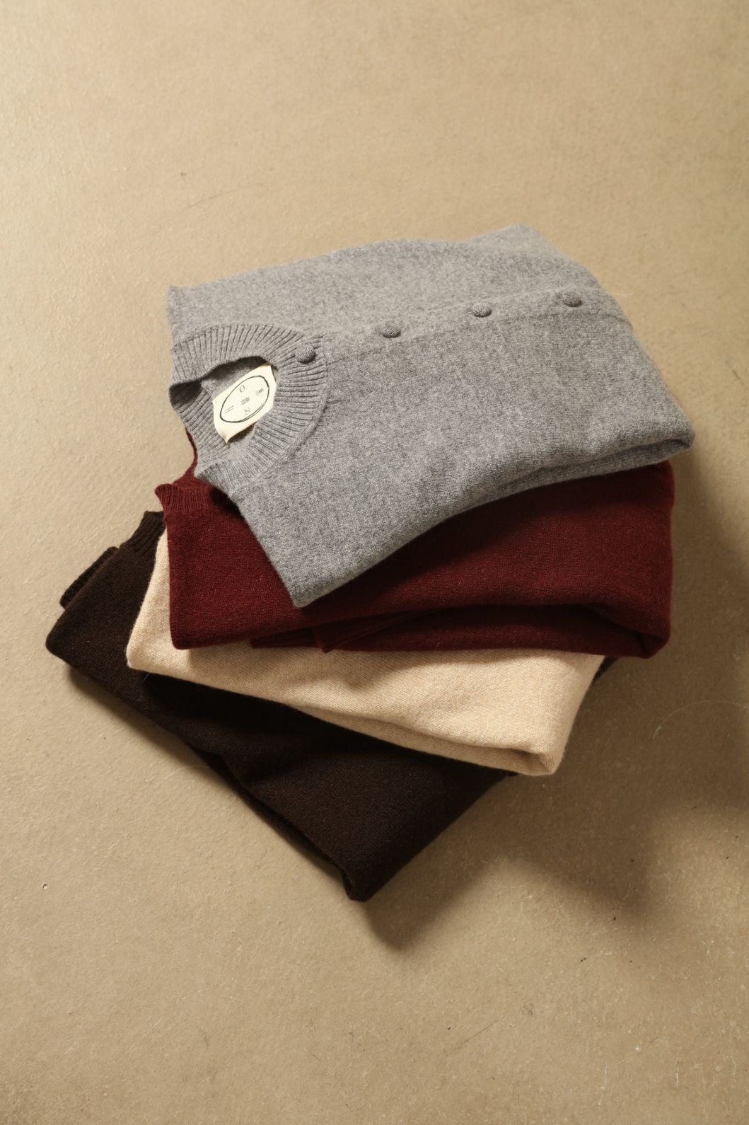 Model wearing the Burgundy Nathalie Cashmere Cardigan by House of Woven Stories, made from 100% pure Inner Mongolia cashmere, featuring a deep burgundy shade, open-front design, relaxed silhouette, flowing drape, and sustainable luxury craftsmanship