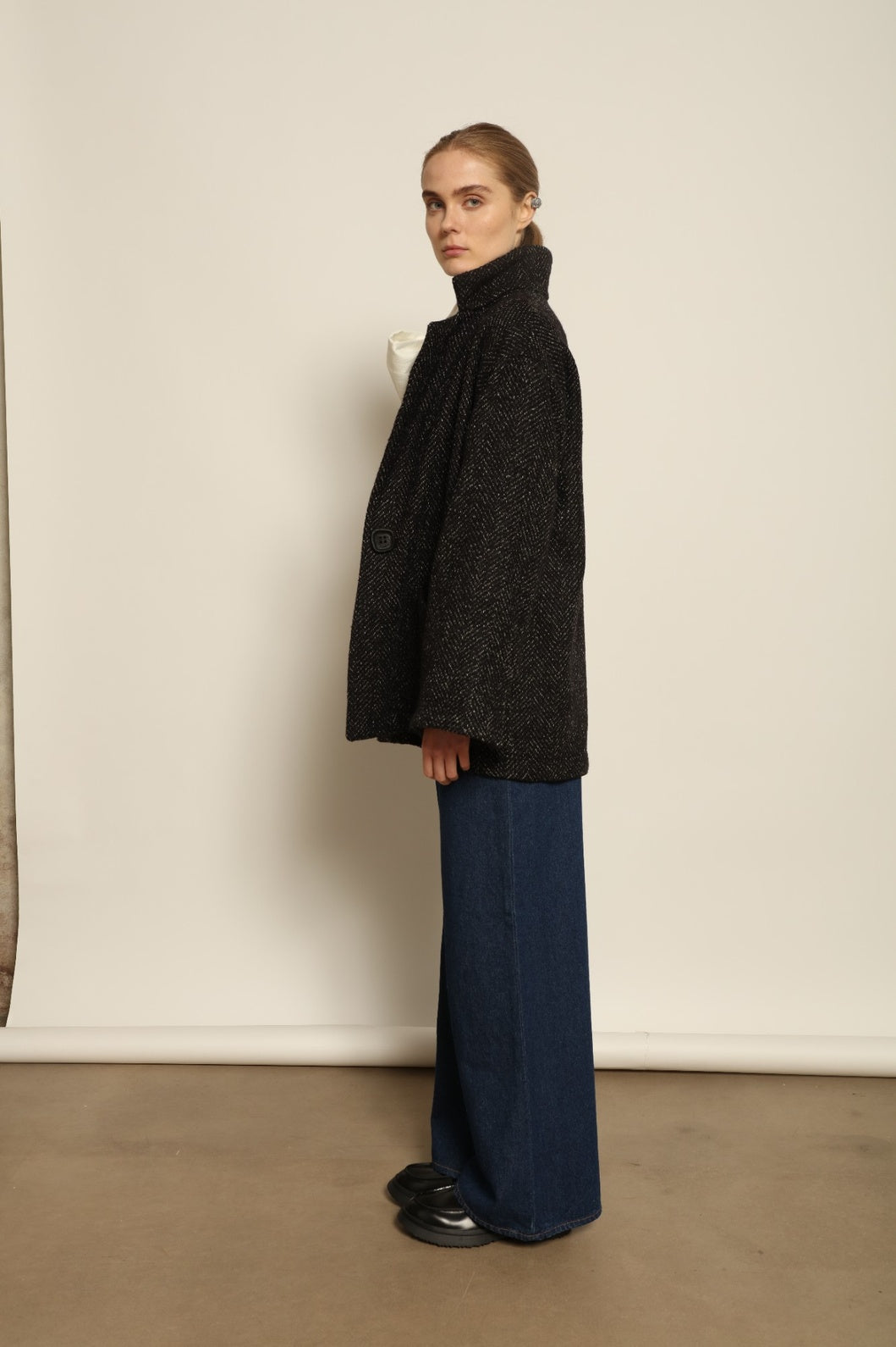 Model is wearing the Carla Maxi Chevron Blazer by House of Woven Stories, crafted from premium Merino wool with chevron weave and an oversized silhouette, combining timeless refinement with modern tailoring.