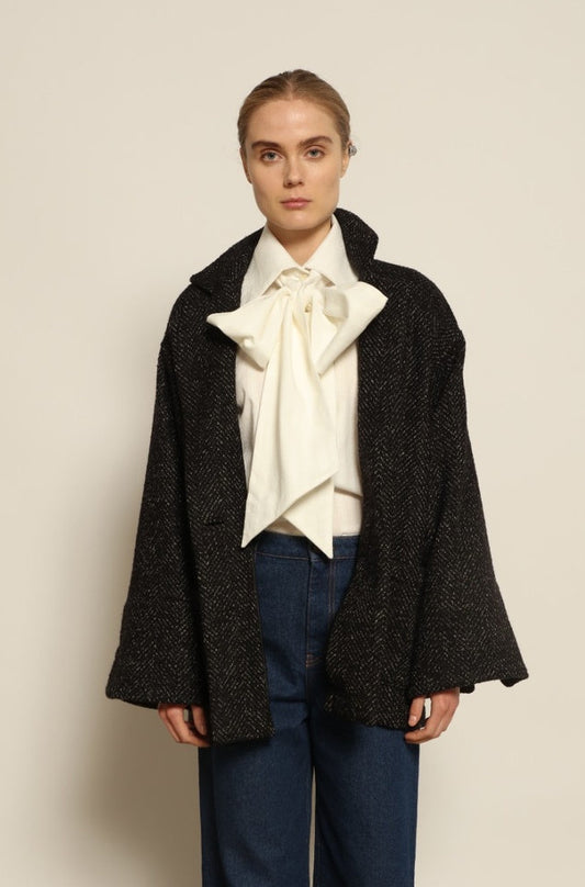 Model is wearing the Carla Maxi Chevron Blazer by House of Woven Stories, crafted from premium Merino wool with chevron weave and an oversized silhouette, combining timeless refinement with modern tailoring.