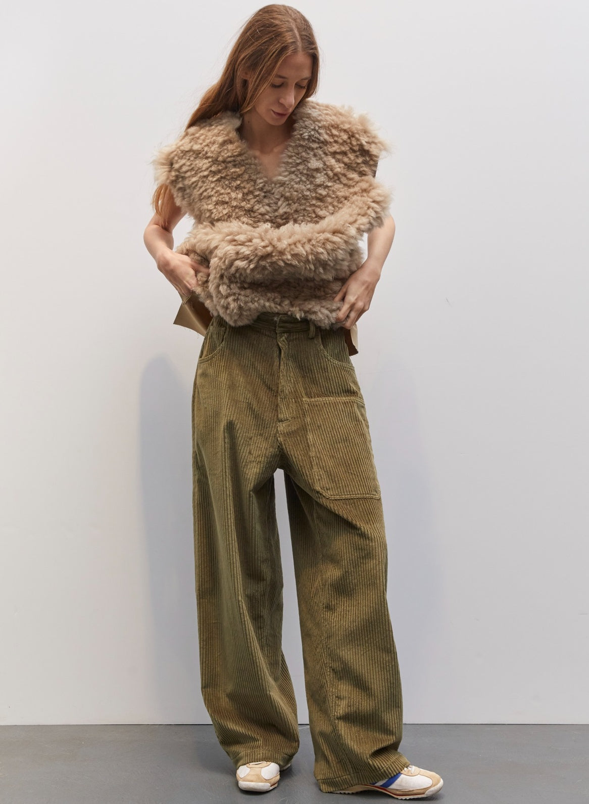 Model wearing the Carla Military Green Velvet Pant by Maison Jejia, part of the House of Woven Stories selection, featuring plush velvet, relaxed tailored silhouette, and deep military green tone