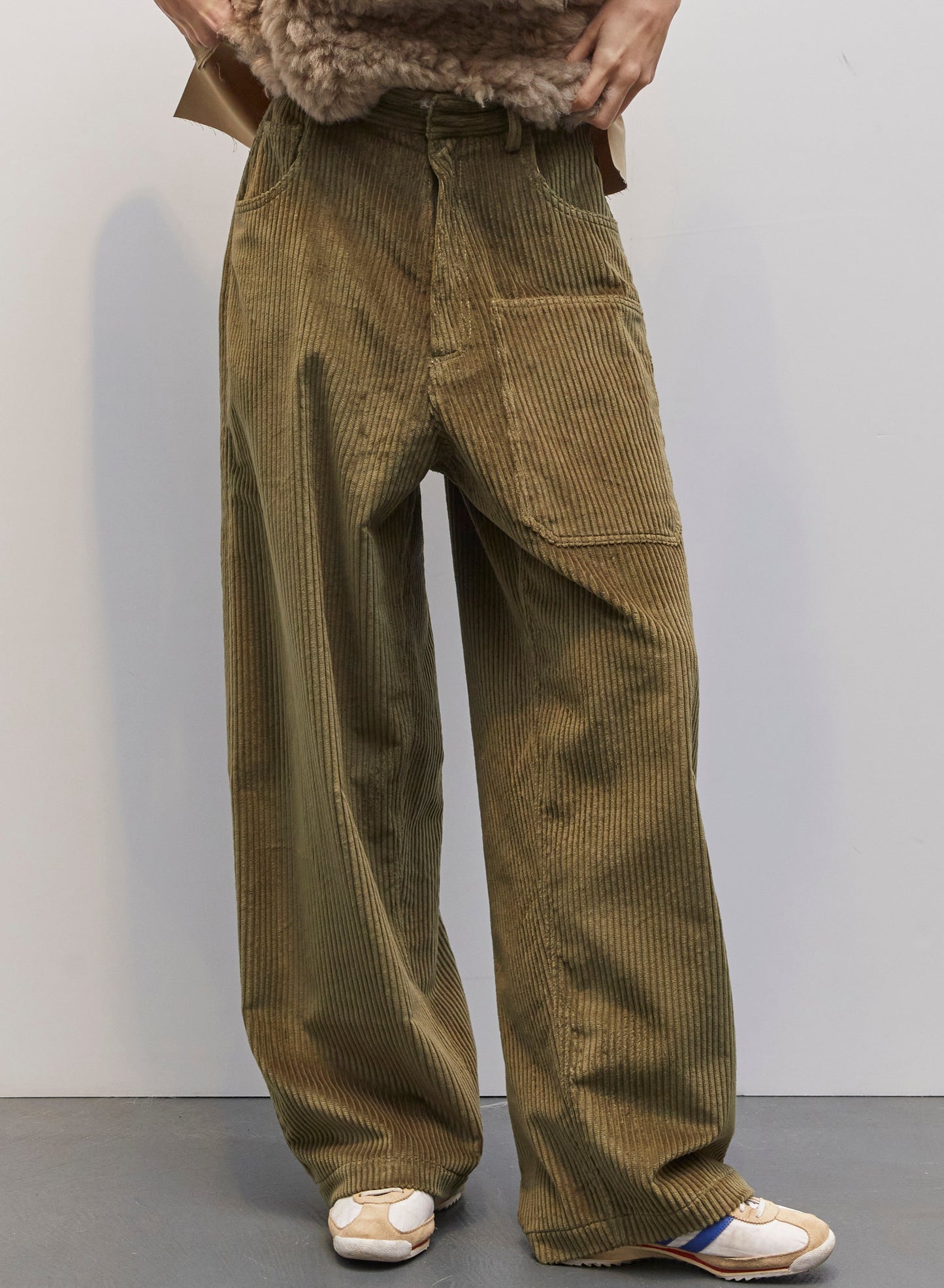 Model wearing the Carla Military Green Velvet Pant by Maison Jejia, part of the House of Woven Stories selection, featuring plush velvet, relaxed tailored silhouette, and deep military green tone