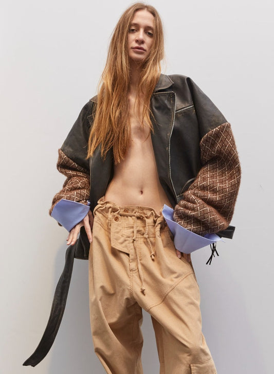 Model wearing the Carlo Dark Brown Biker Leather Pull by Maison Jejia, featuring oversized sculptural silhouette, textured leather sleeves, exaggerated cuffs, and fluid drape for a contemporary, refined biker-inspired look