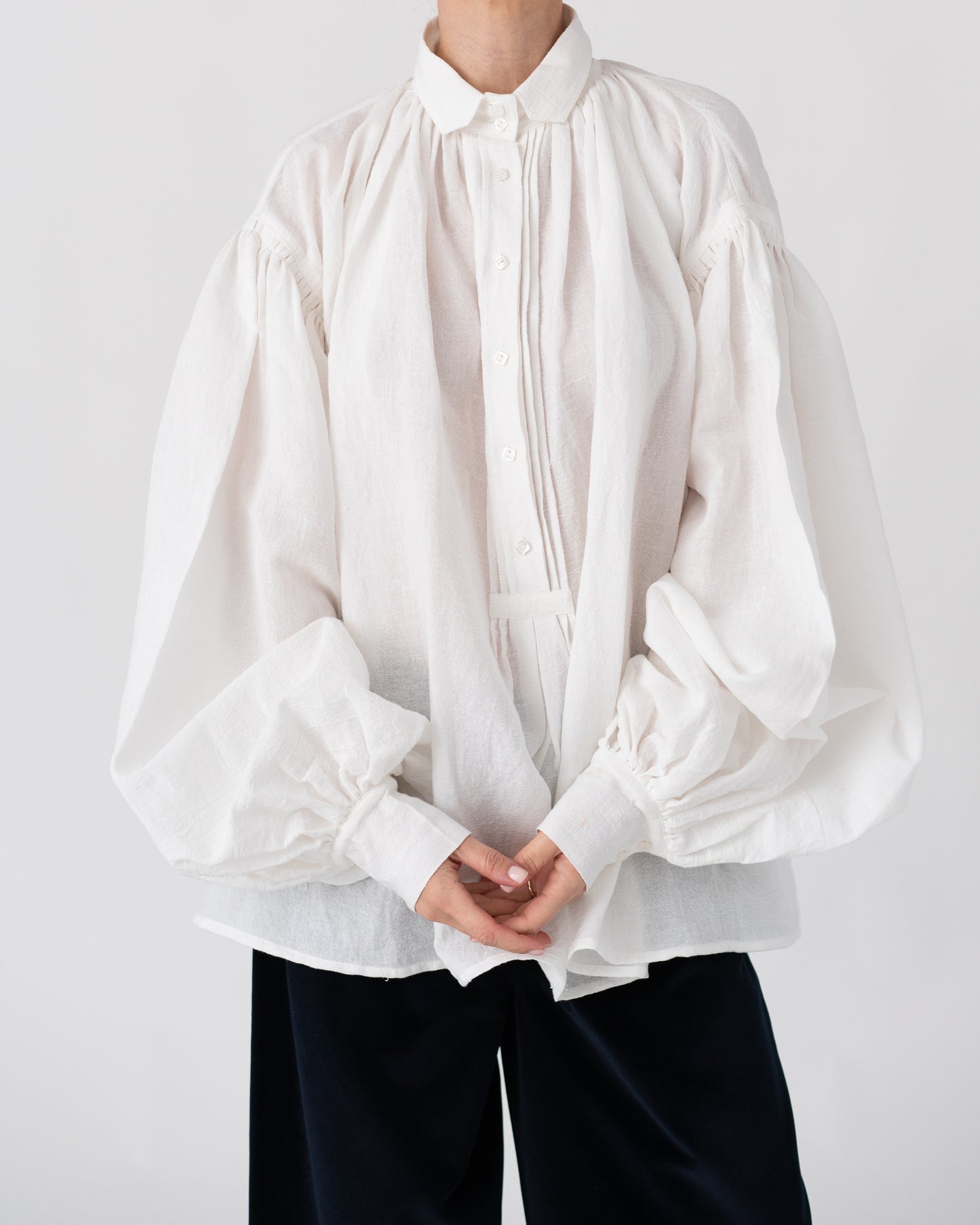 Model is wearing the Carmen Blouse by Les Vacances d’Irina, a hand-stitched linen-cotton shirt with wide sleeves and square buttons, reimagining a traditional Romanian silhouette, available at House of Woven Stories.
