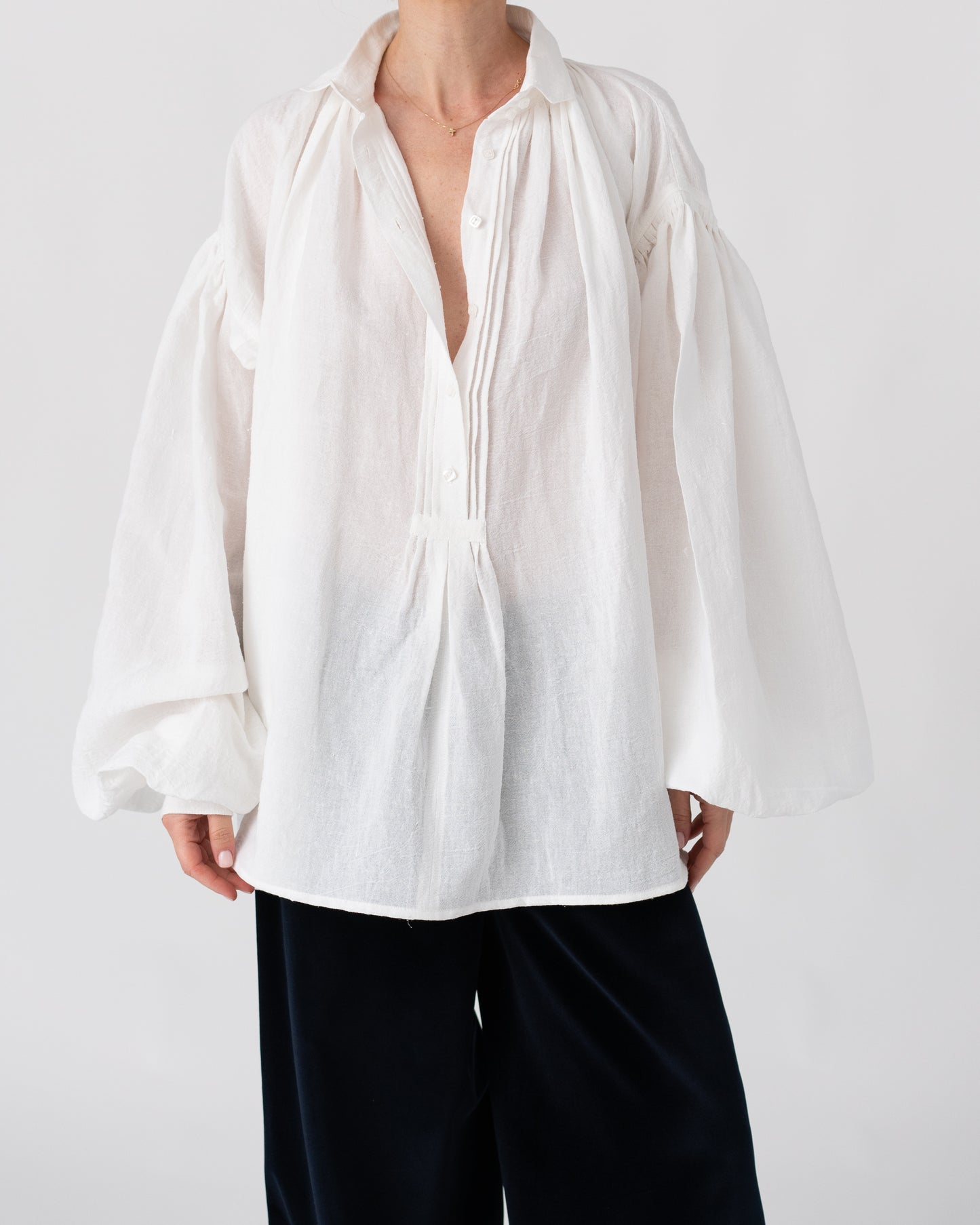 Model is wearing the Carmen Blouse by Les Vacances d’Irina, a hand-stitched linen-cotton shirt with wide sleeves and square buttons, reimagining a traditional Romanian silhouette, available at House of Woven Stories.