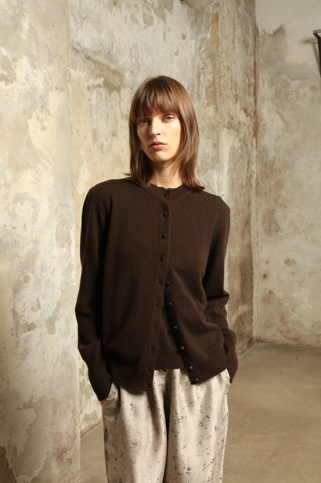 Model wearing the Chocolate Nathalie Open-Front Cashmere Cardigan by House of Woven Stories, crafted from 100% Inner Mongolia cashmere, featuring a relaxed silhouette, smooth texture, and sustainable luxury knitwear in rich chocolate tone