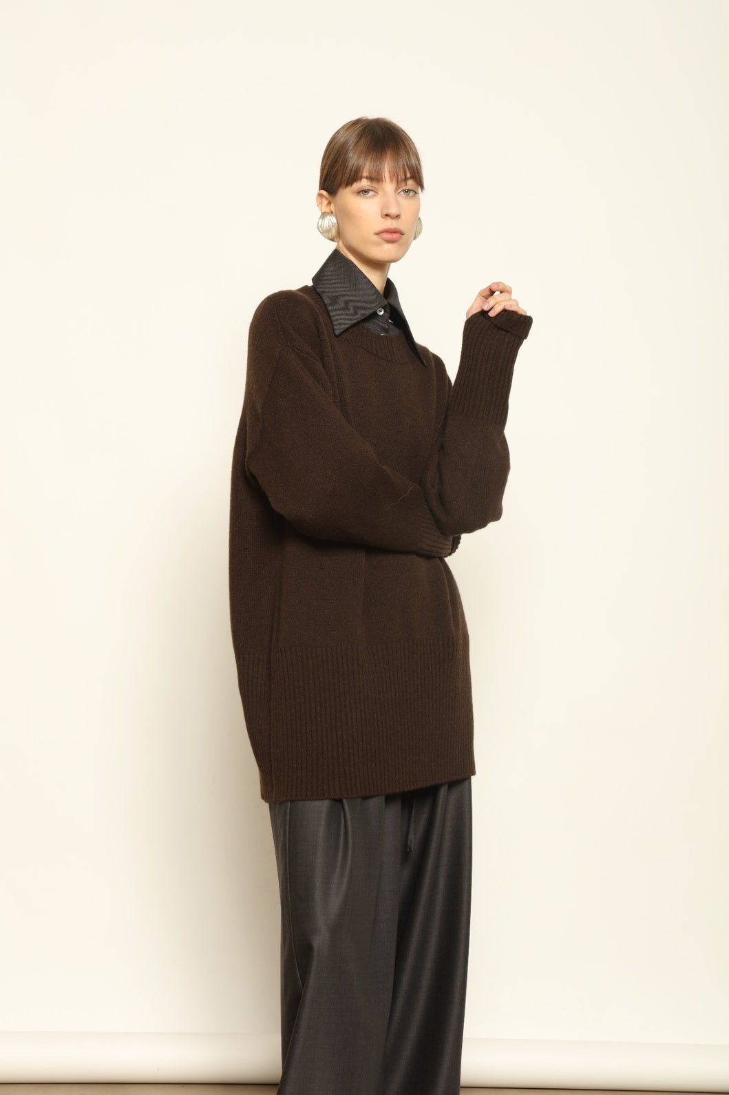 Model wearing the Chocolate Noemi Round Neck Cashmere Pullover by House of Woven Stories, made from 100% pure Inner Mongolia cashmere, featuring a deep chocolate tone, soft texture, relaxed fit, and sustainable luxury craftsmanship