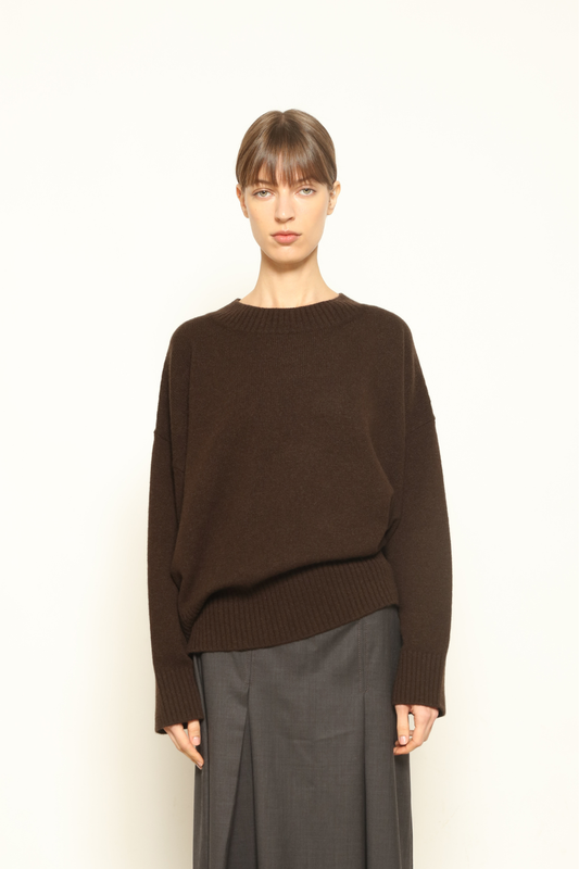 Model is wearing the chocolate Noemi Round Neck Pullover by House of Woven Stories, made from 100% pure Inner Mongolia cashmere, featuring ultra-soft, breathable, durable knitwear, relaxed fit, and timeless luxury craftsmanship