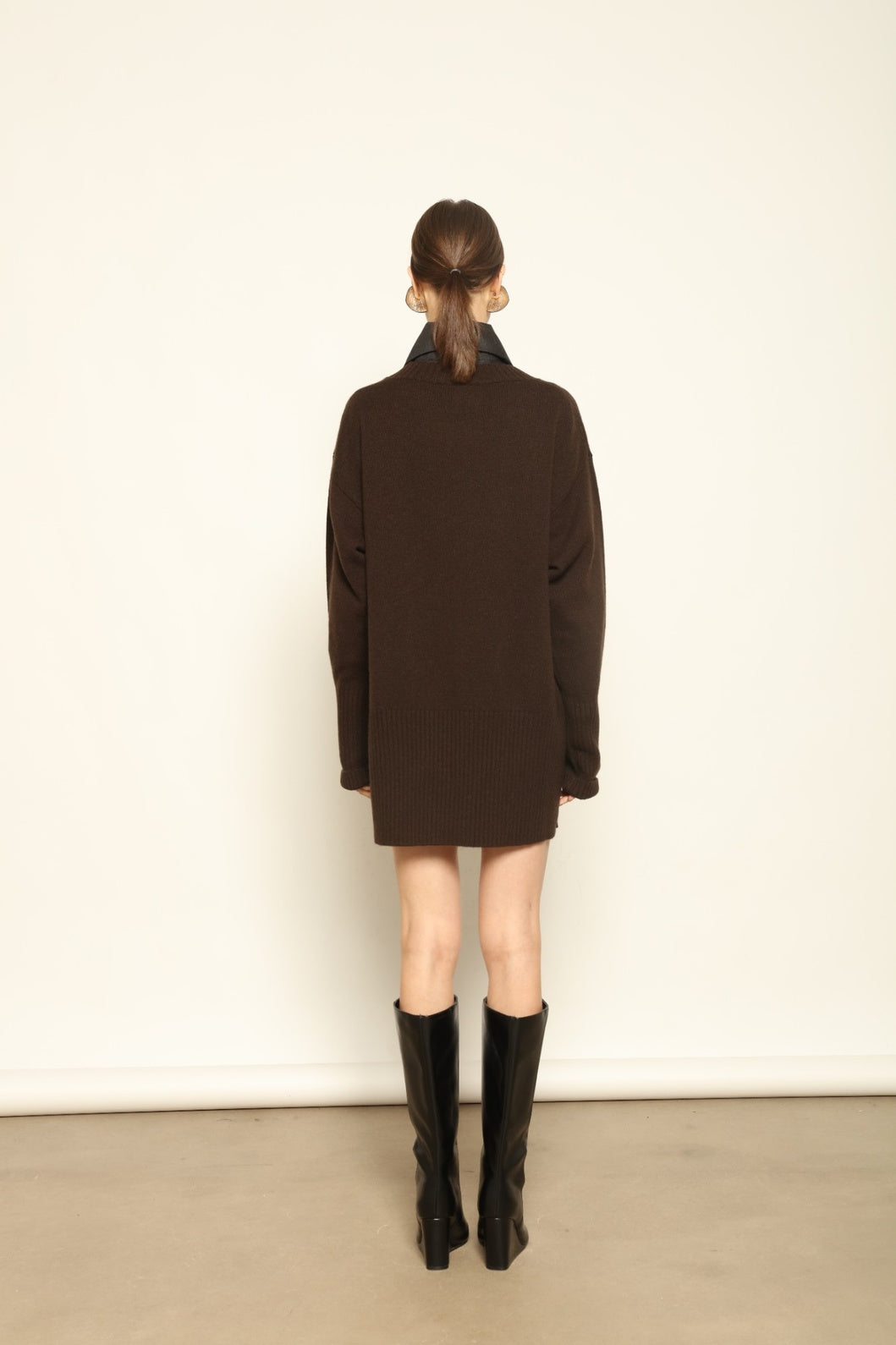 Model wearing the Chocolate Noemi Round Neck Cashmere Pullover by House of Woven Stories, made from 100% pure Inner Mongolia cashmere, featuring a deep chocolate tone, soft texture, relaxed fit, and sustainable luxury craftsmanship