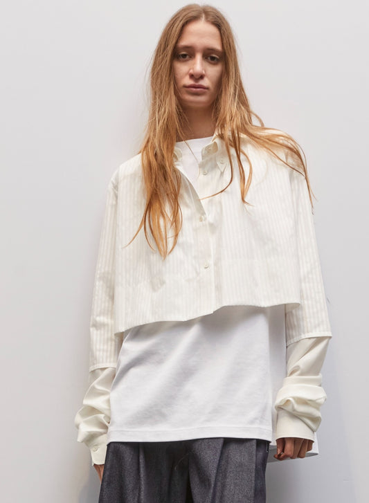 Model wearing the Crazy White Cotton Stripes Shirt Baby by Maison Jejia, featuring crisp white cotton, subtle vertical stripes, layered cropped design, soft extended sleeves, and modern playful tailoring, part of the House of Woven Stories Selection