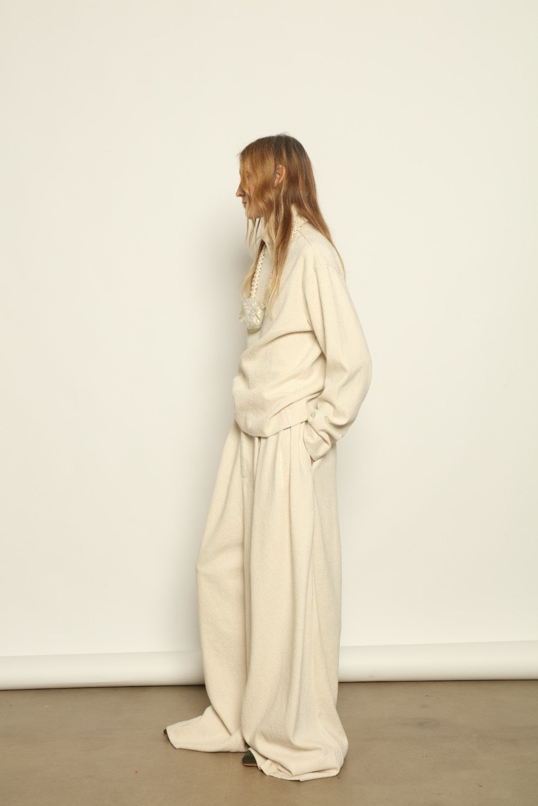 Model is wearing the Ecru Bouclé Solid Turtleneck by Marrakshi Life, part of House of Nomad Stories collection, handwoven cotton bouclé top with relaxed turtleneck, soft texture, and versatile fit