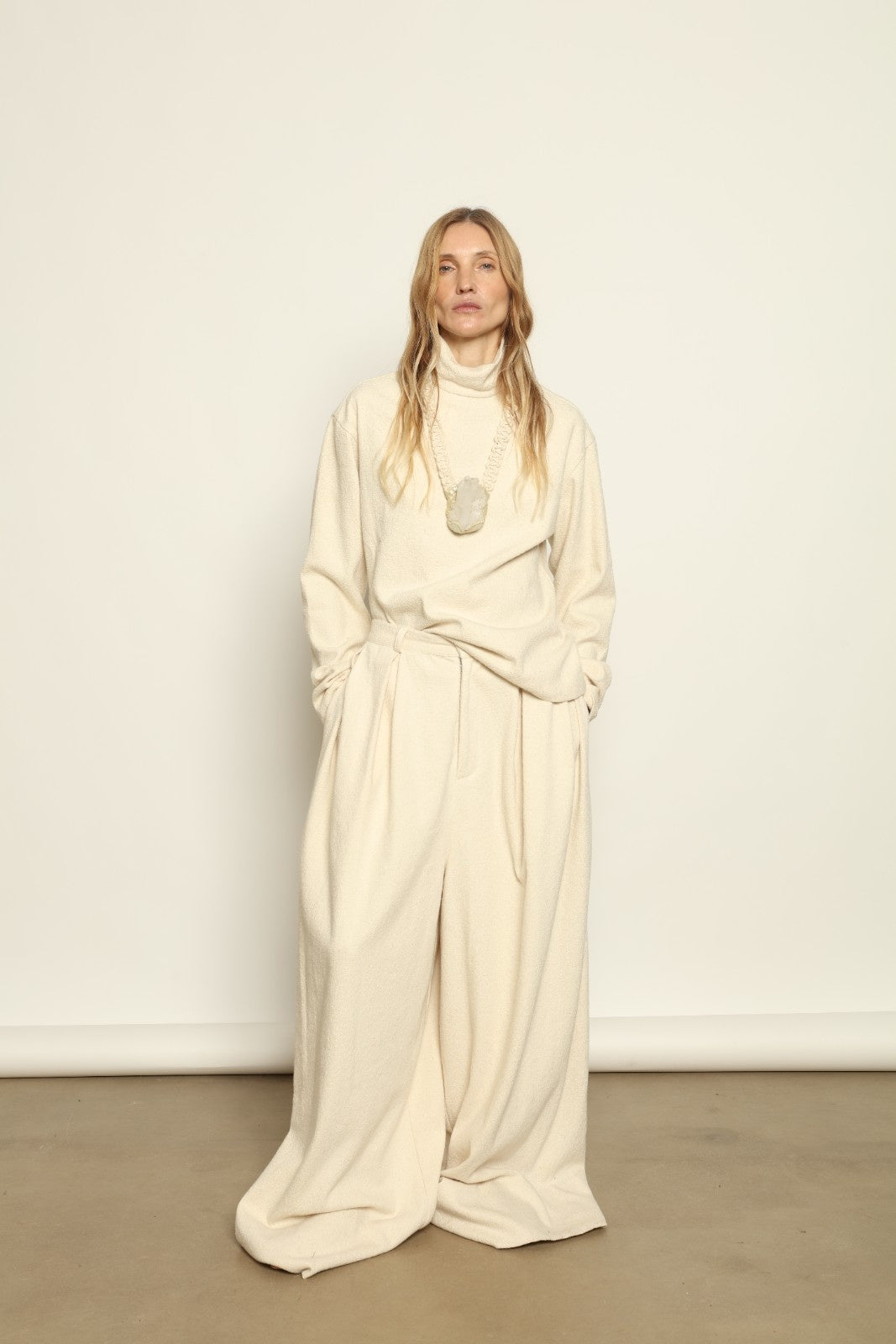 Model is wearing the Ecru Bouclé Solid Turtleneck by Marrakshi Life, part of House of Nomad Stories collection, handwoven cotton bouclé top with relaxed turtleneck, soft texture, and versatile fit