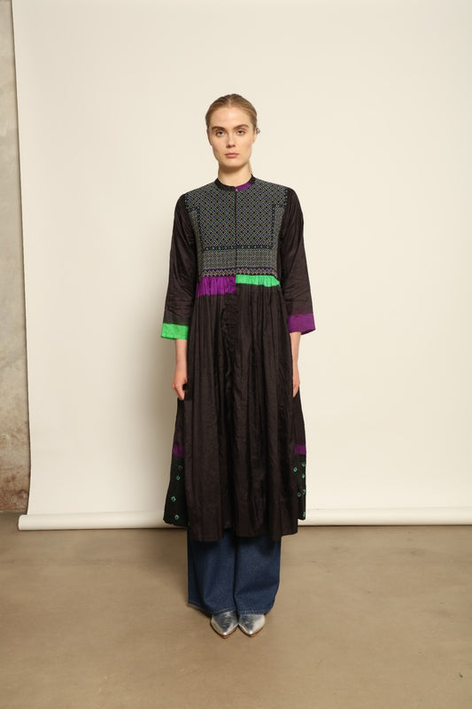 Model is wearing Folklore 10 Handmade Cotton and Silk Dress by Injiri, part of the House of Woven Stories selection, crafted in India from a cotton and silk blend with round neckline, long sleeves, side pockets, and artisanal detailing.