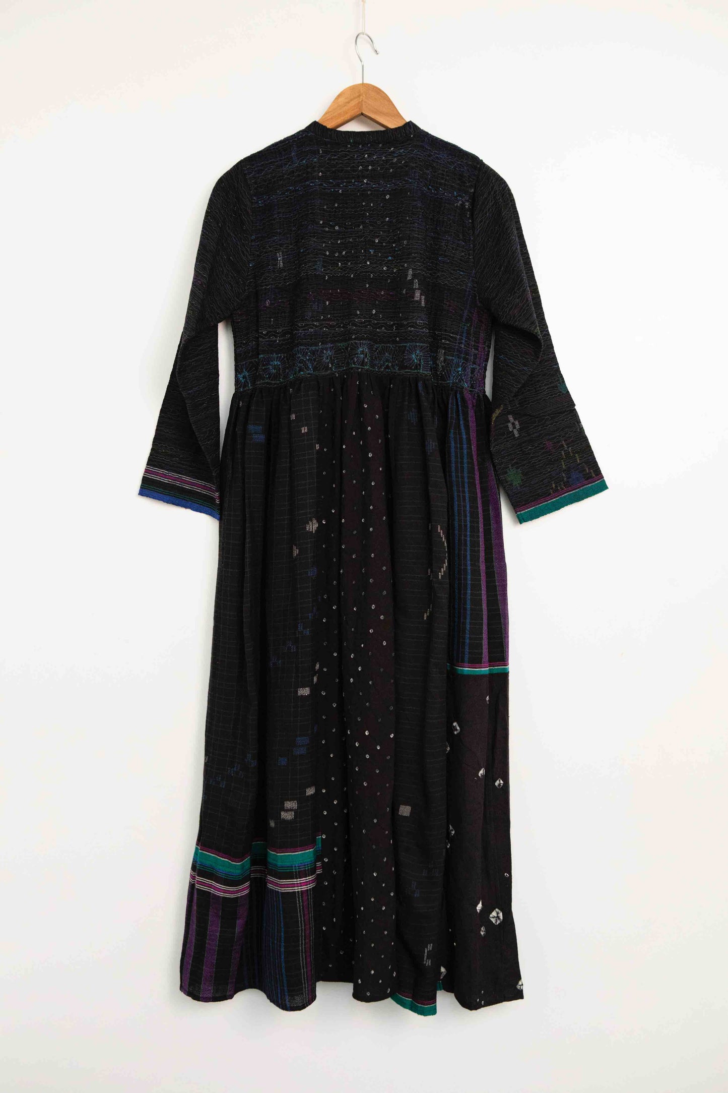 Model is wearing the Folklore 20 handloomed silk and wool dress by Injiri, featuring a flattering cut, long sleeves, side pockets, and artisan-made handloomed fabric.
