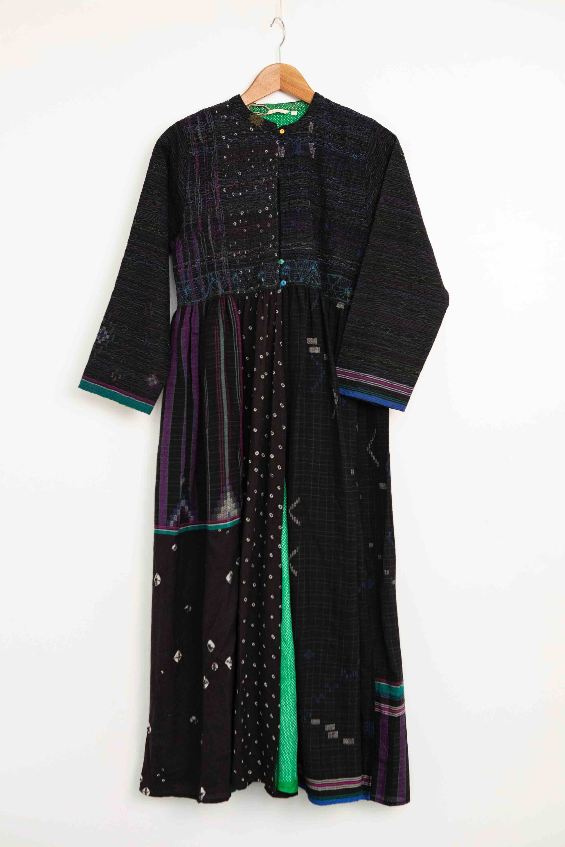 Model is wearing the Folklore 20 handloomed silk and wool dress by Injiri, featuring a flattering cut, long sleeves, side pockets, and artisan-made handloomed fabric.
