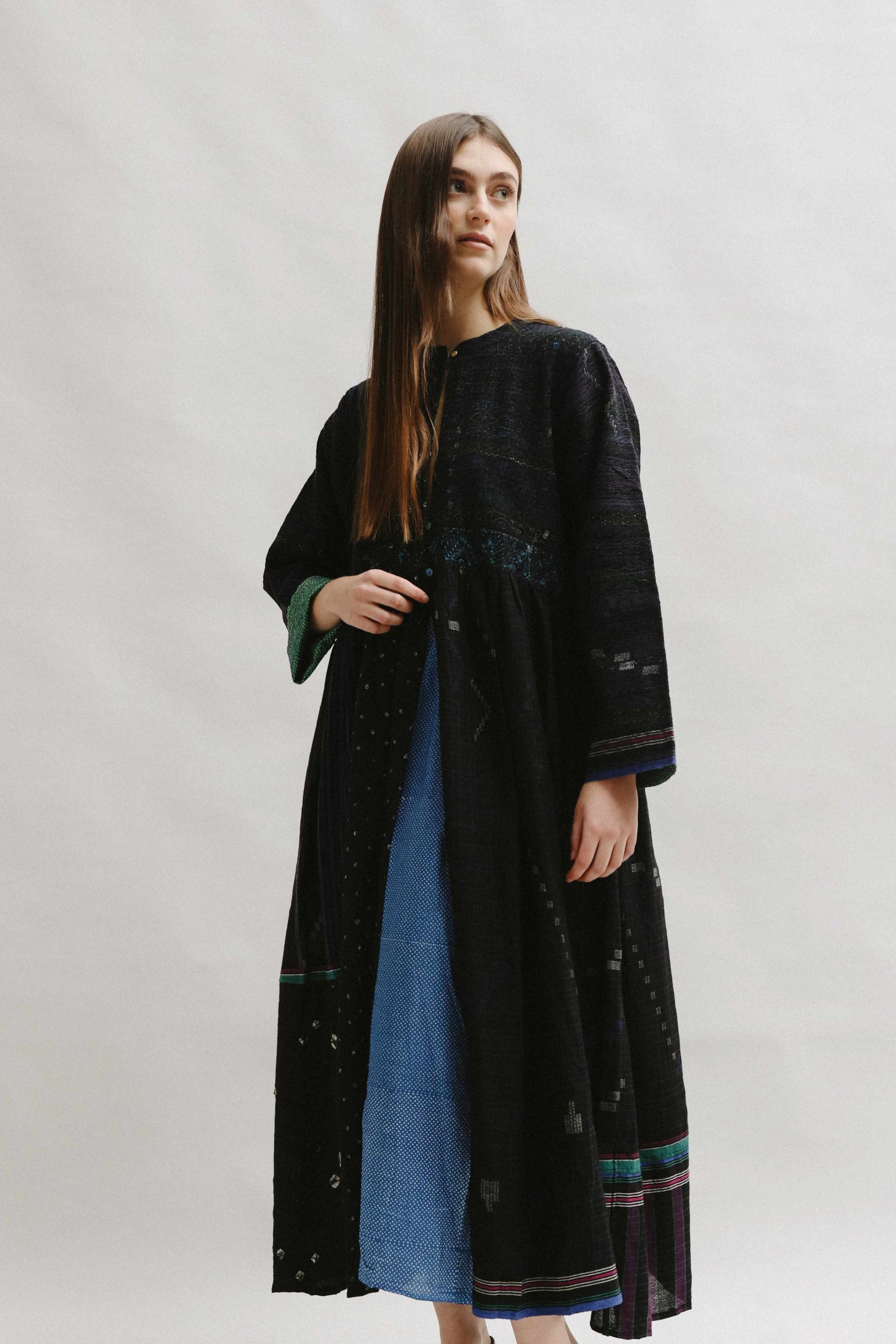 Model is wearing the Folklore 20 handloomed silk and wool dress by Injiri, featuring a flattering cut, long sleeves, side pockets, and artisan-made handloomed fabric.